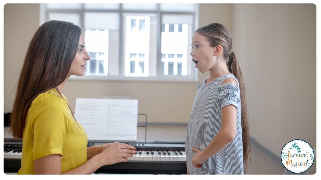 a little girl is taking a vocal lesson at her coach's house, and the vocal coach is sitting in front of the piano assessing the little girl's range while she is singing